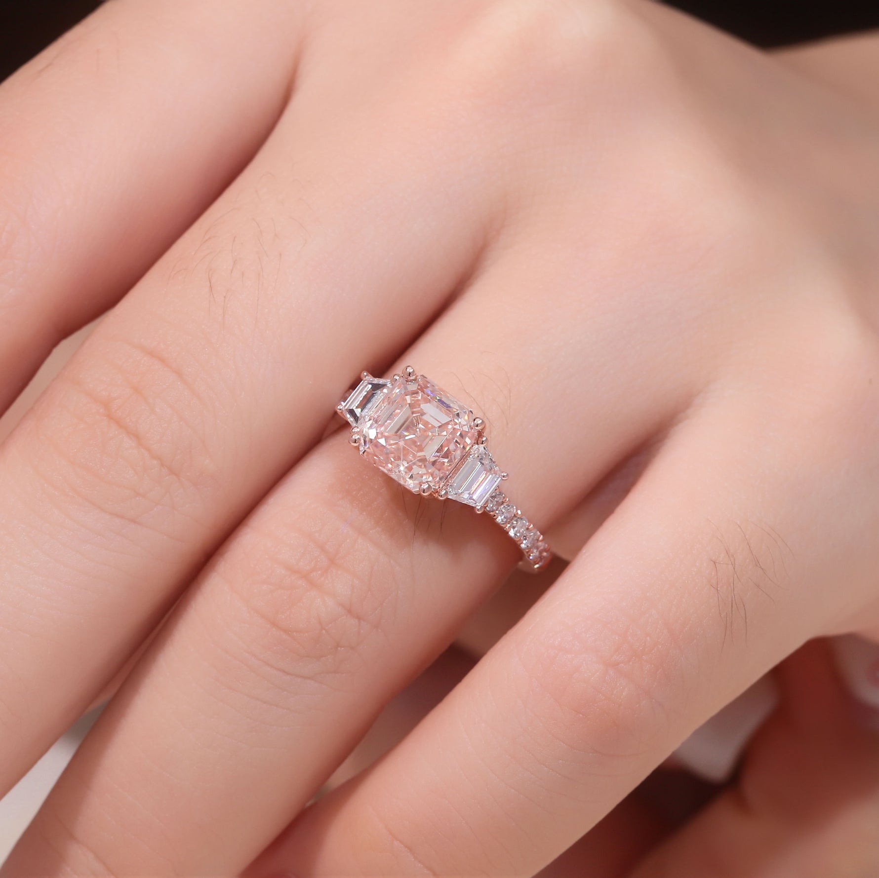 Asscher cut pink lab diamond three stone ring in rose gold with tapered baguette side stones