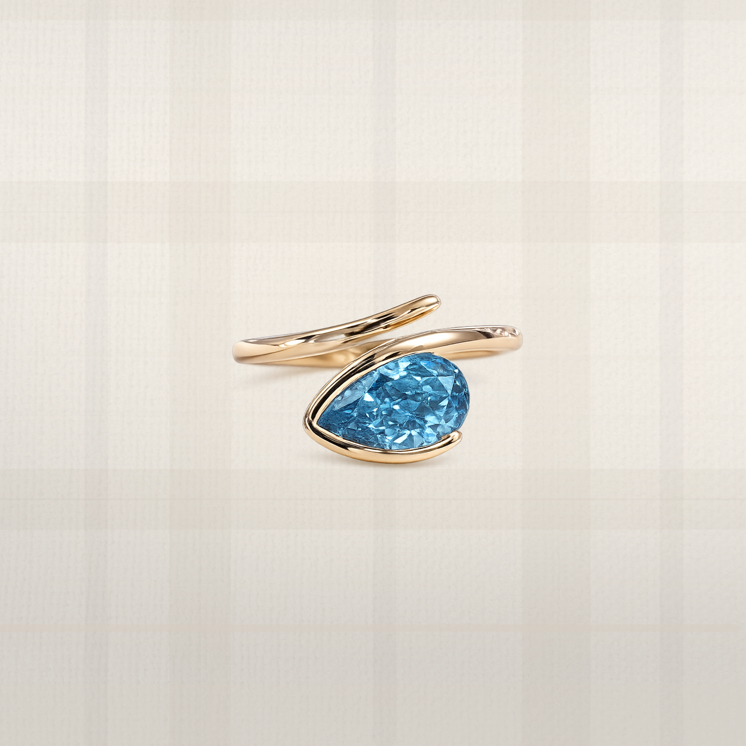 Pear cut blue lab diamond ring in yellow gold with sculptural bypass setting