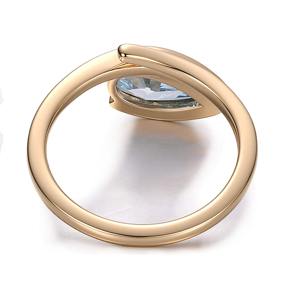 Inner band detail of blue lab grown diamond pear ring with sculptural gold bypass design